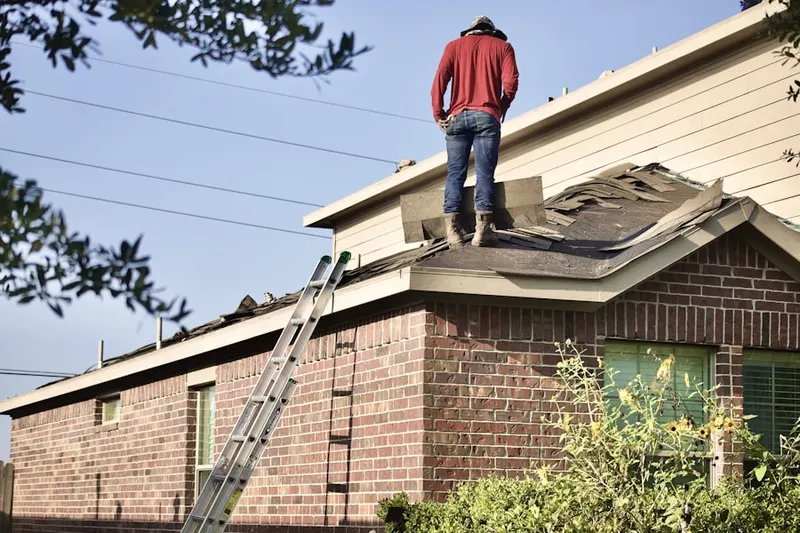 Professional roofer working on a residential roof in Tradesville